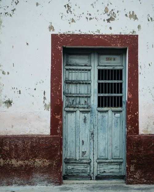 Free A rustic wooden door with red frame in Yucatan, showcasing weathered charm. Stock Photo