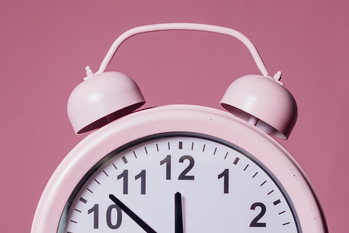 Close-Up Photo of Pink Alarm Clock