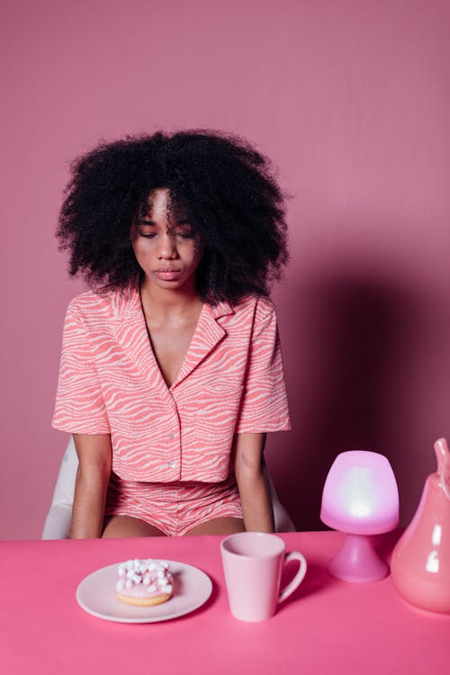 Woman in Pink Top Looking at the Table