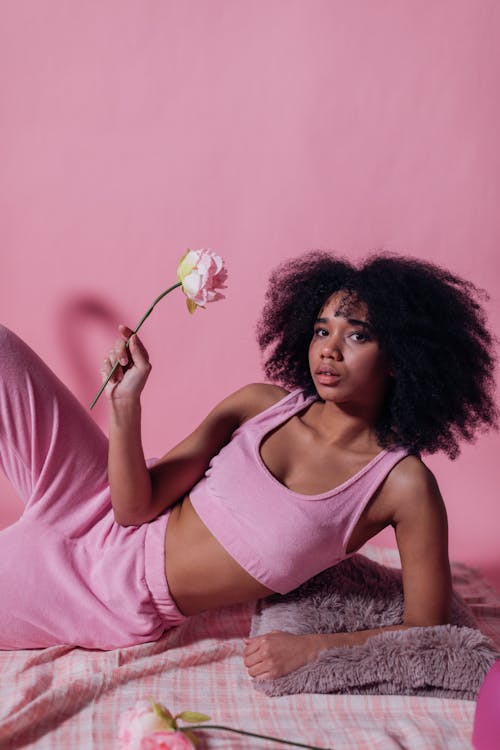 Woman in Pink Crop Top Holding a Pink Rose