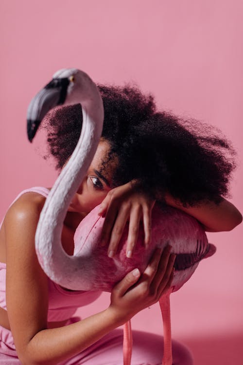 Woman Holding onto a Pink Flamingo