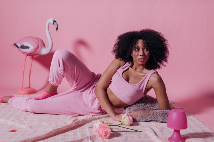 Woman In Pink Crop Top And Jogging Pants On Pink Background