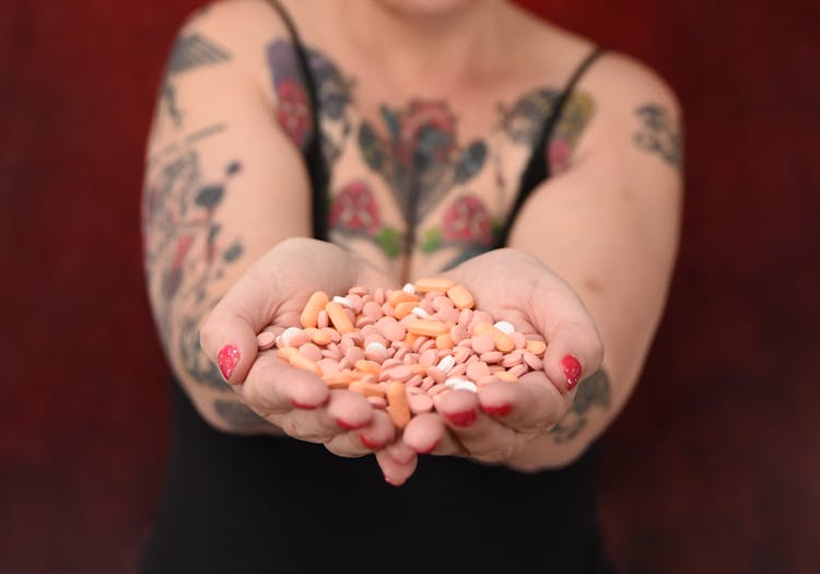 Close-Up Photograph Of Medicine Pills On A Person's Hands