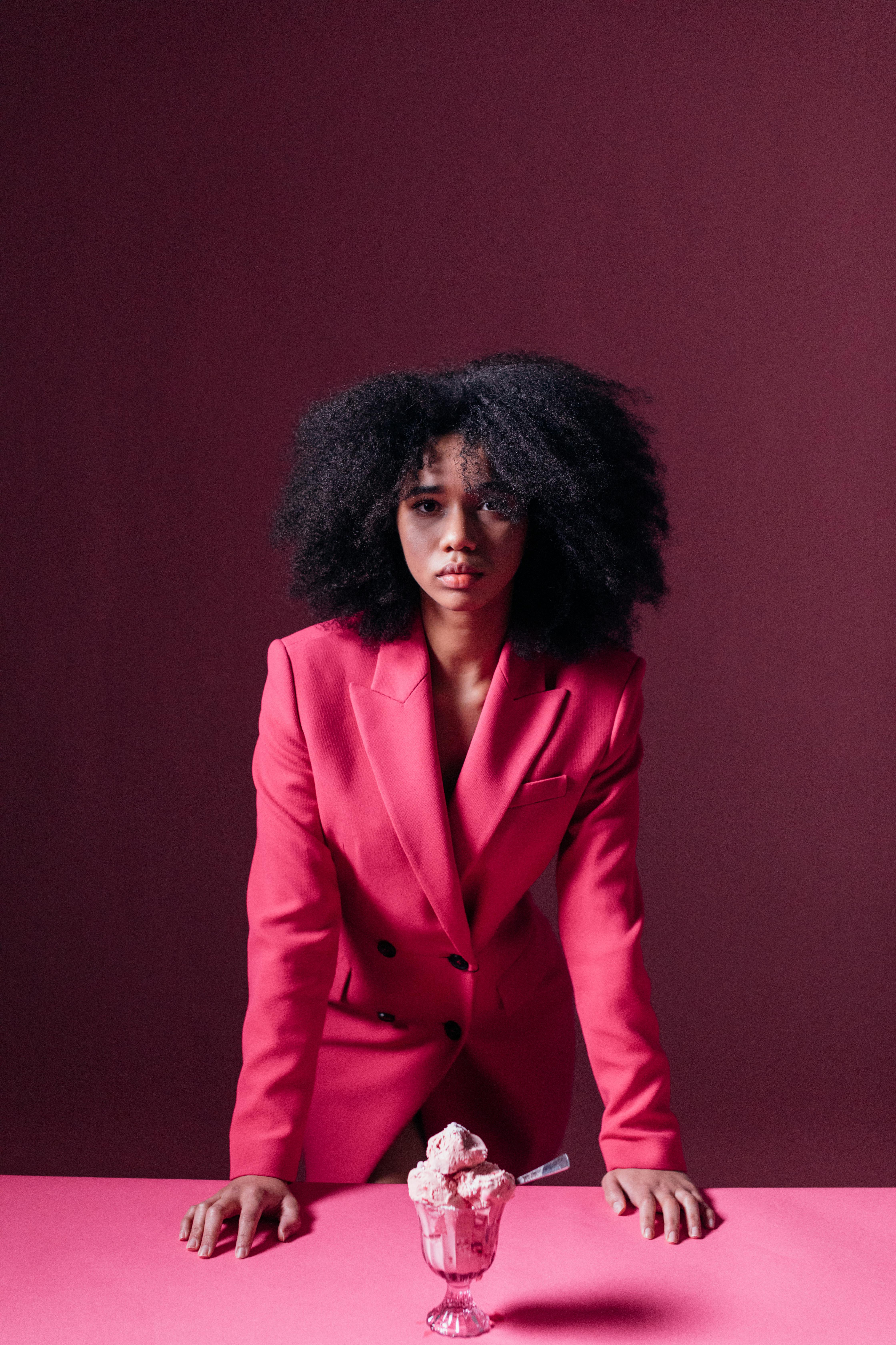 woman in pink suit looking at the camera