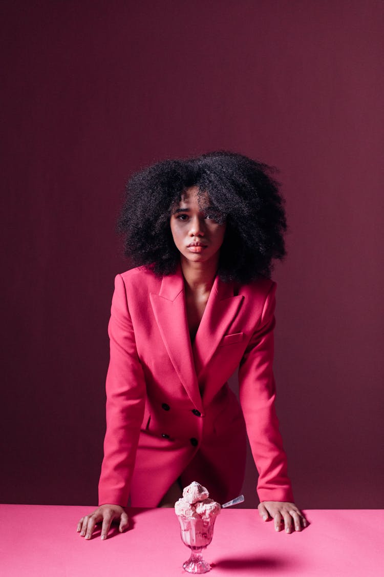 Woman In Pink Suit Looking At The Camera