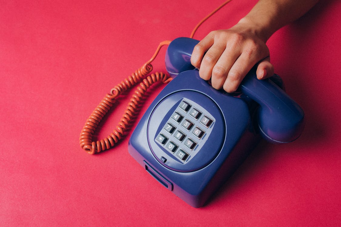 Free Person Holding an Old Corded Telephone Stock Photo