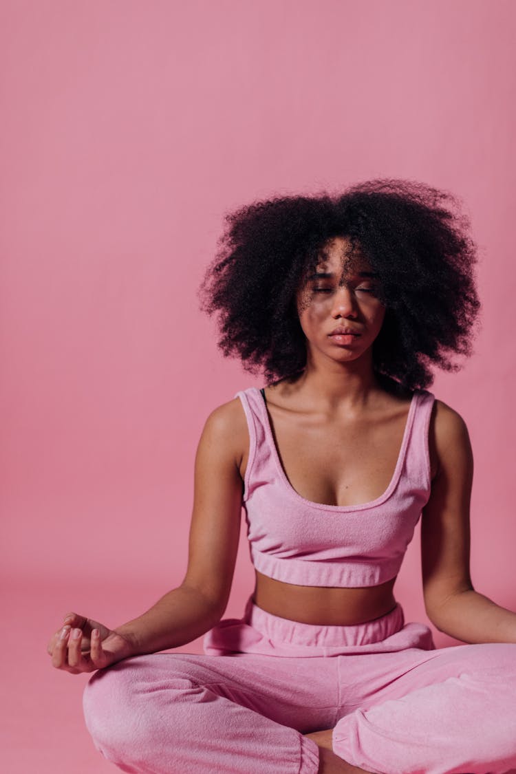 Woman In Pink Crop Top And Jogging Pants Practicing Yoga