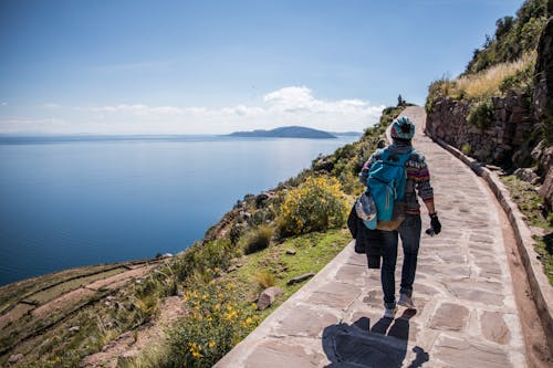 Person Walking on a Walkway on Mountainside