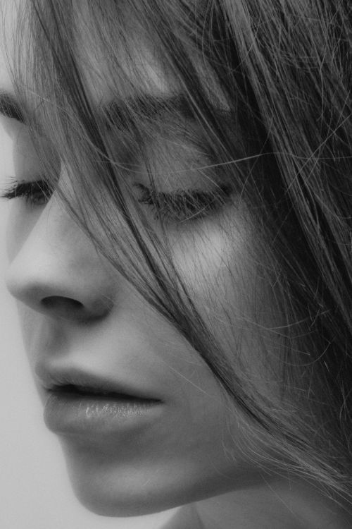Free Artistic monochrome close-up of a woman's face, highlighting facial details. Stock Photo