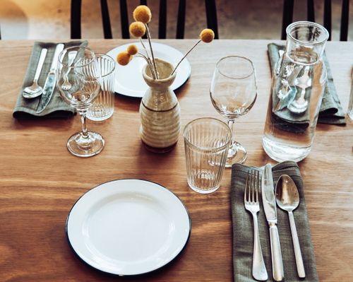 Free A charming table setup with cutlery, glassware, and yellow Craspedia flowers in Sydney, Australia. Stock Photo