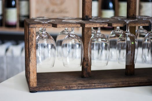 Rustic wooden rack holding inverted wine glasses in a Rioja winery.