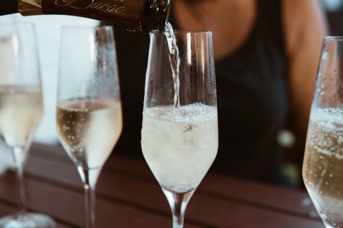 Free Close-up of champagne being poured into flutes, perfect for celebrations and parties. Stock Photo