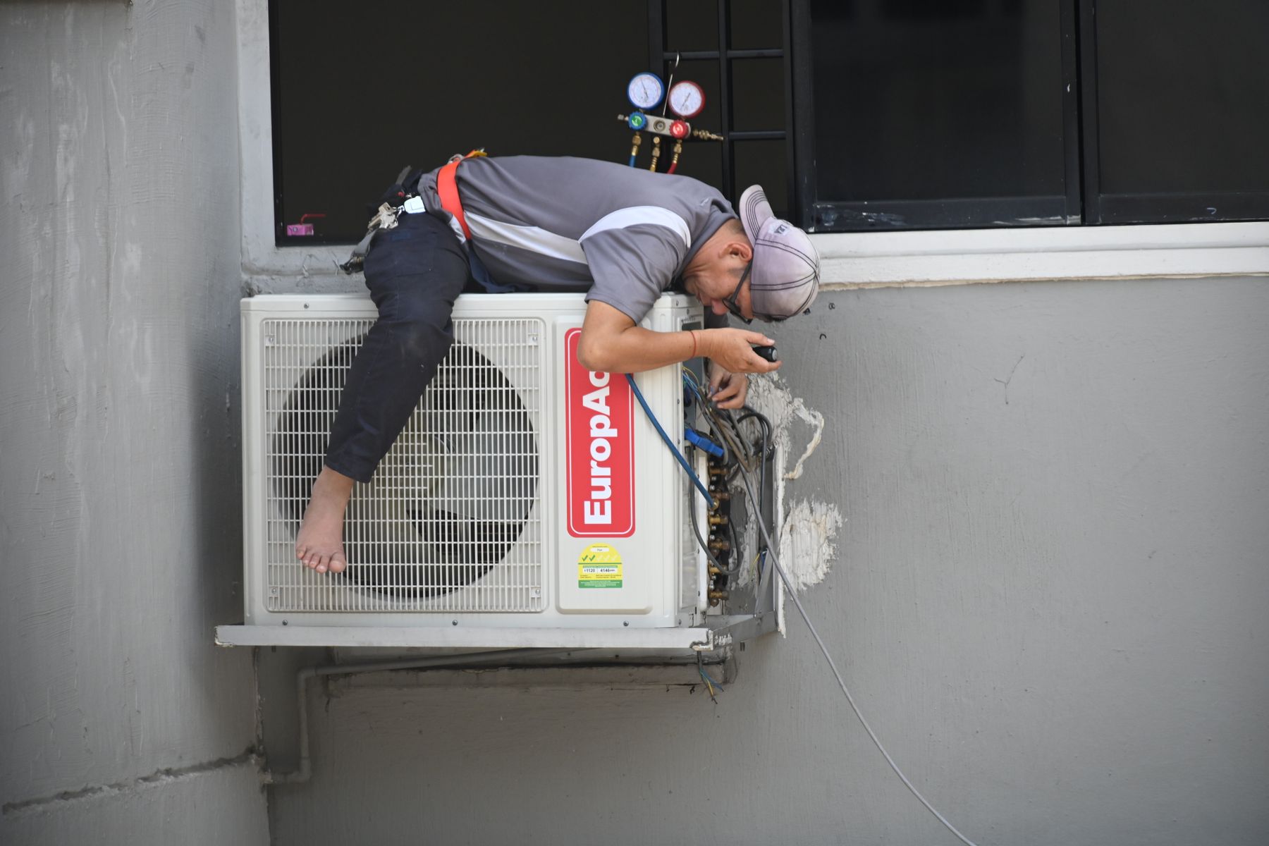 HVAC technician servicing an outdoor air-conditioning unit