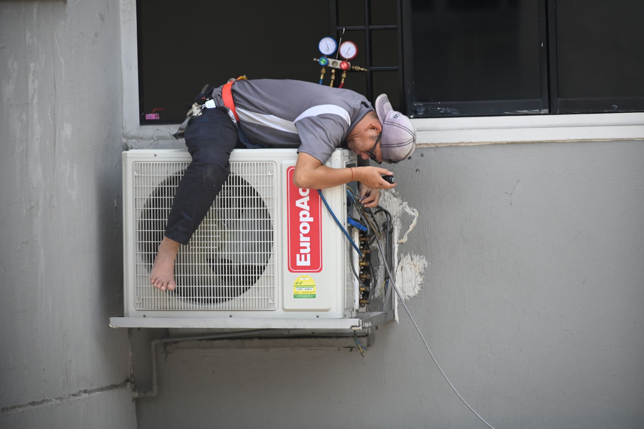 Technician servicing a heating and cooling unit