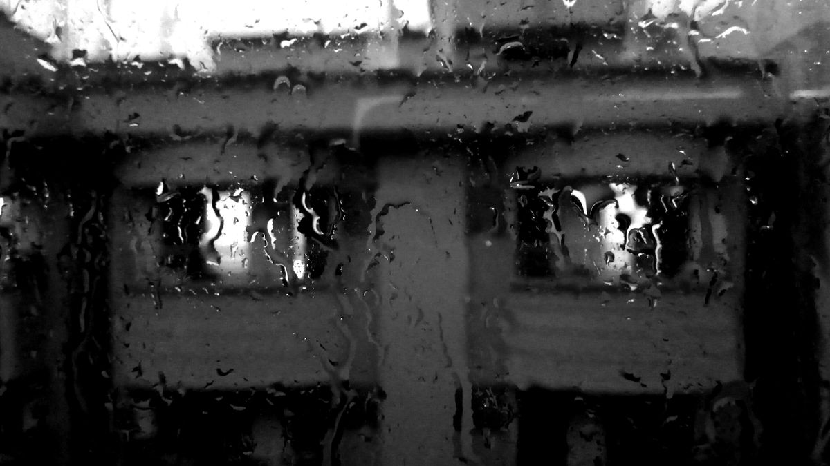 雨に濡れた窓越しの景色(イメージ)