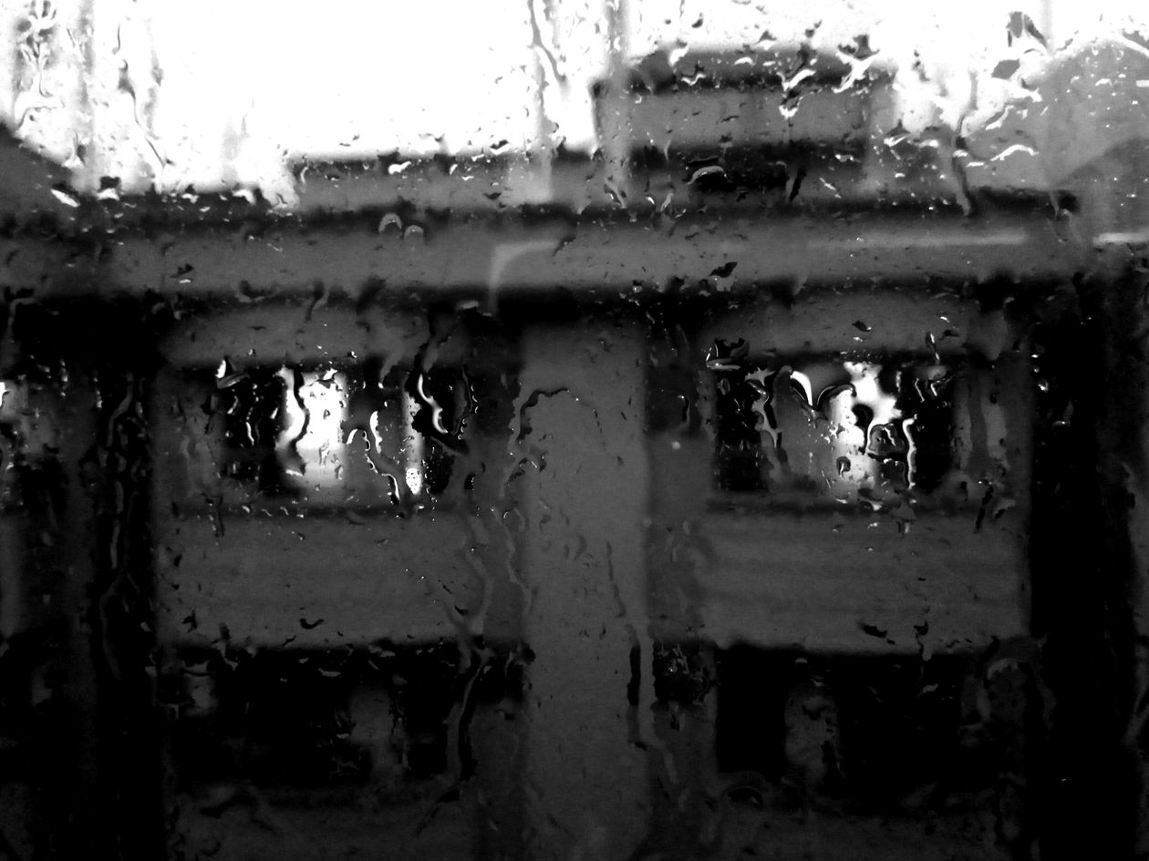 Building seen through a rain-covered window
