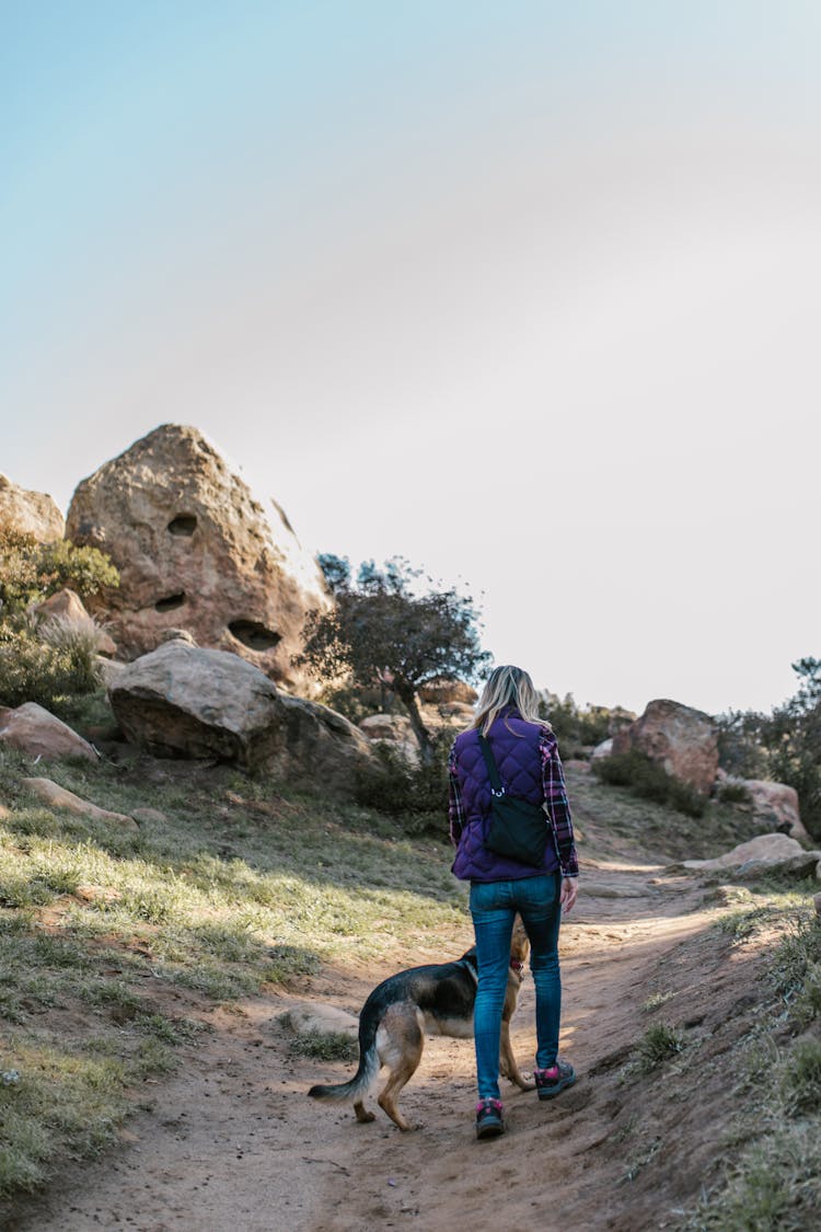 A Woman Hiking With Her Dog