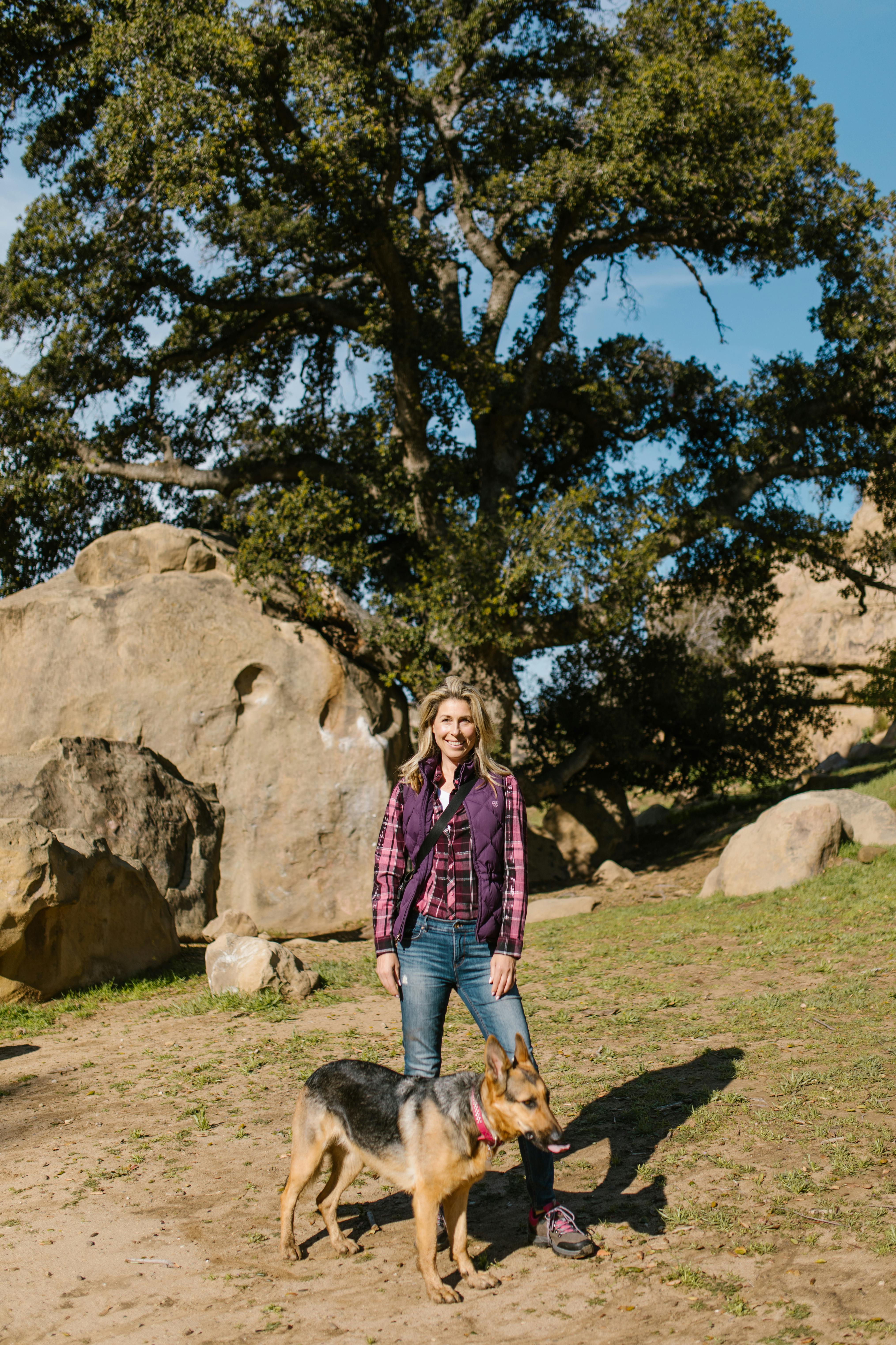 woman wearing a purple vest with her dog