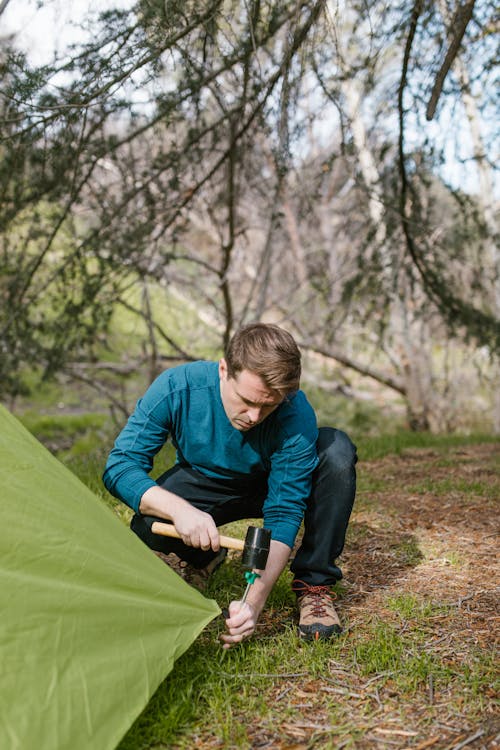 Man Putting Up a Tent