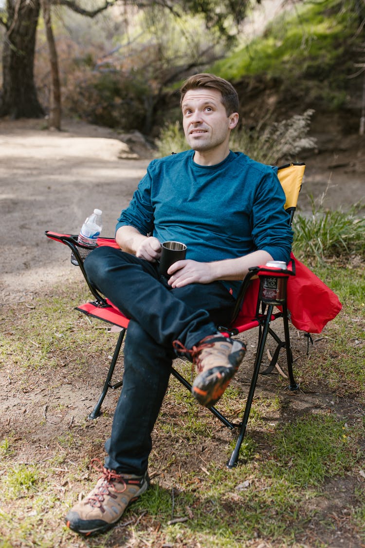 Photo Of A Man Sitting On A Camping Chair