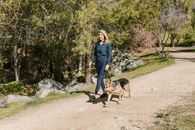 Woman in Blue Denim Jacket Standing Beside German Shepherd Dog