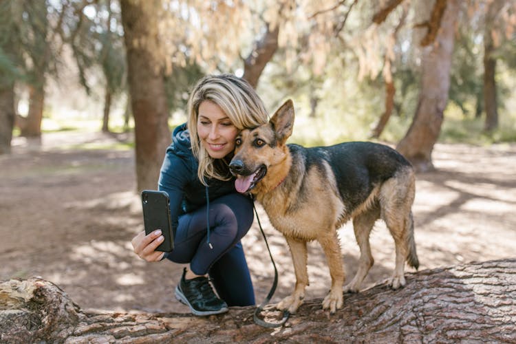 A Woman Taking Selfie With Her Dog