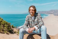 Photograph of a Man in a Plaid Shirt Smiling