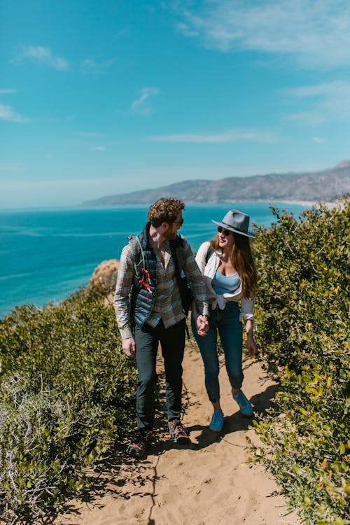 Man and Woman Walking on a Trail