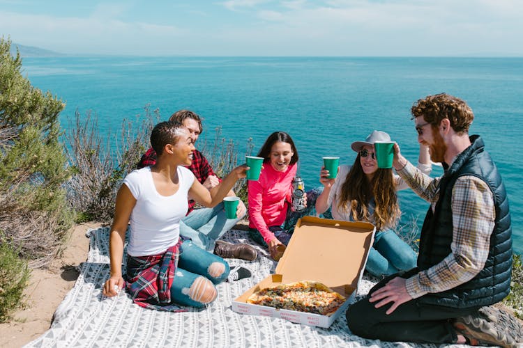 Friends Having Drinks During A Picnic