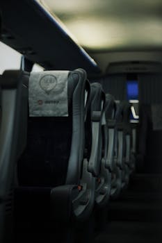 Close-up of empty bus seats in Türkiye with soft lighting, emphasizing travel ambiance.