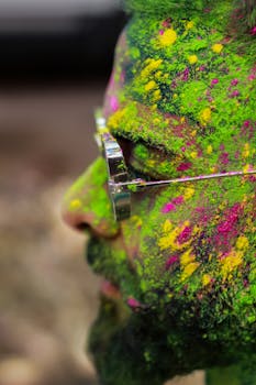 Side profile of a man with colorful powder during Holi festival in Patna, India.