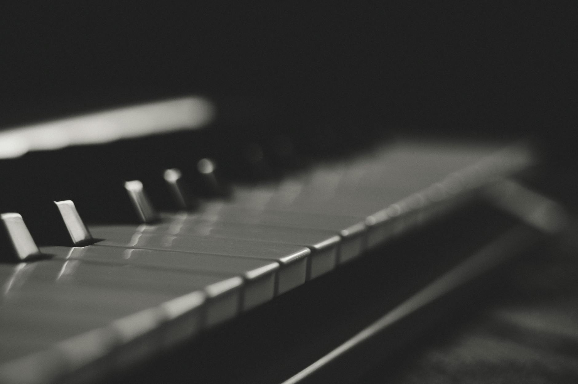 Artistic black and white close-up of piano keys with soft focus and minimalistic