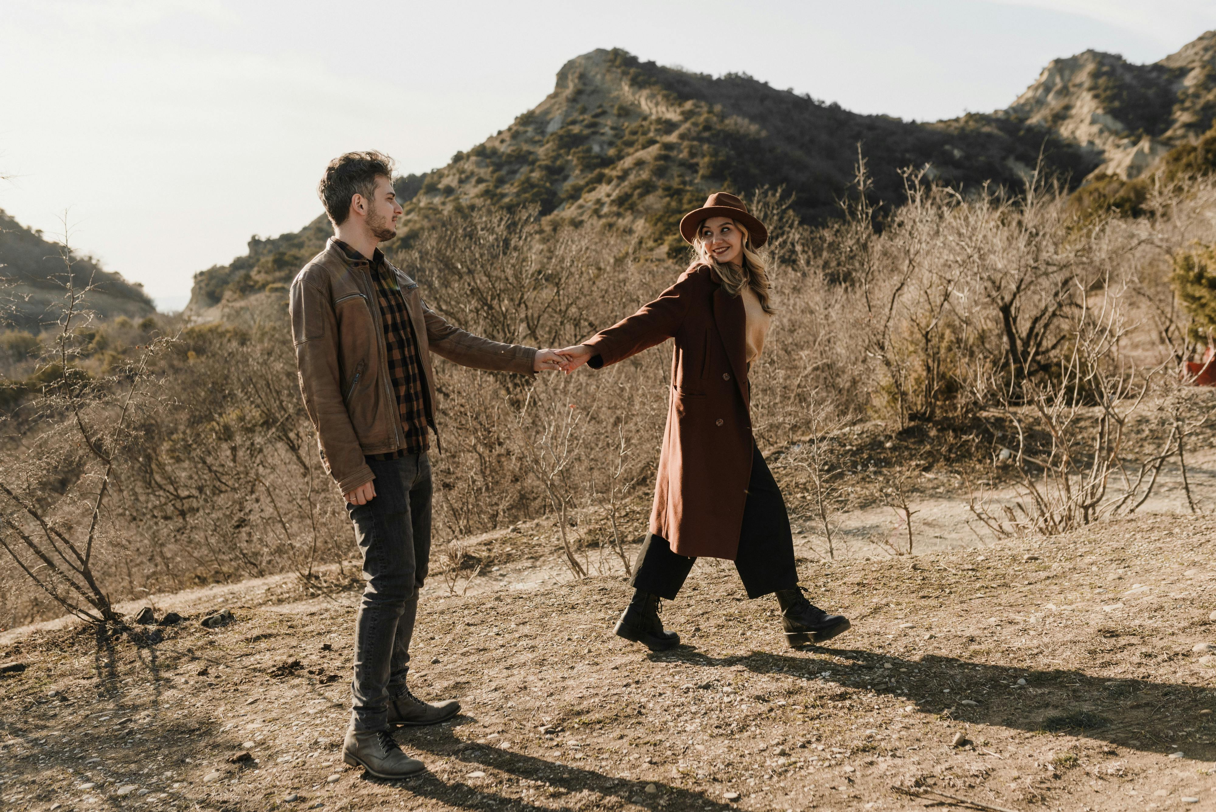 Happy couple enjoying a scenic hike in the Colorado mountains - List the top-rated maid services in Denver, CO.