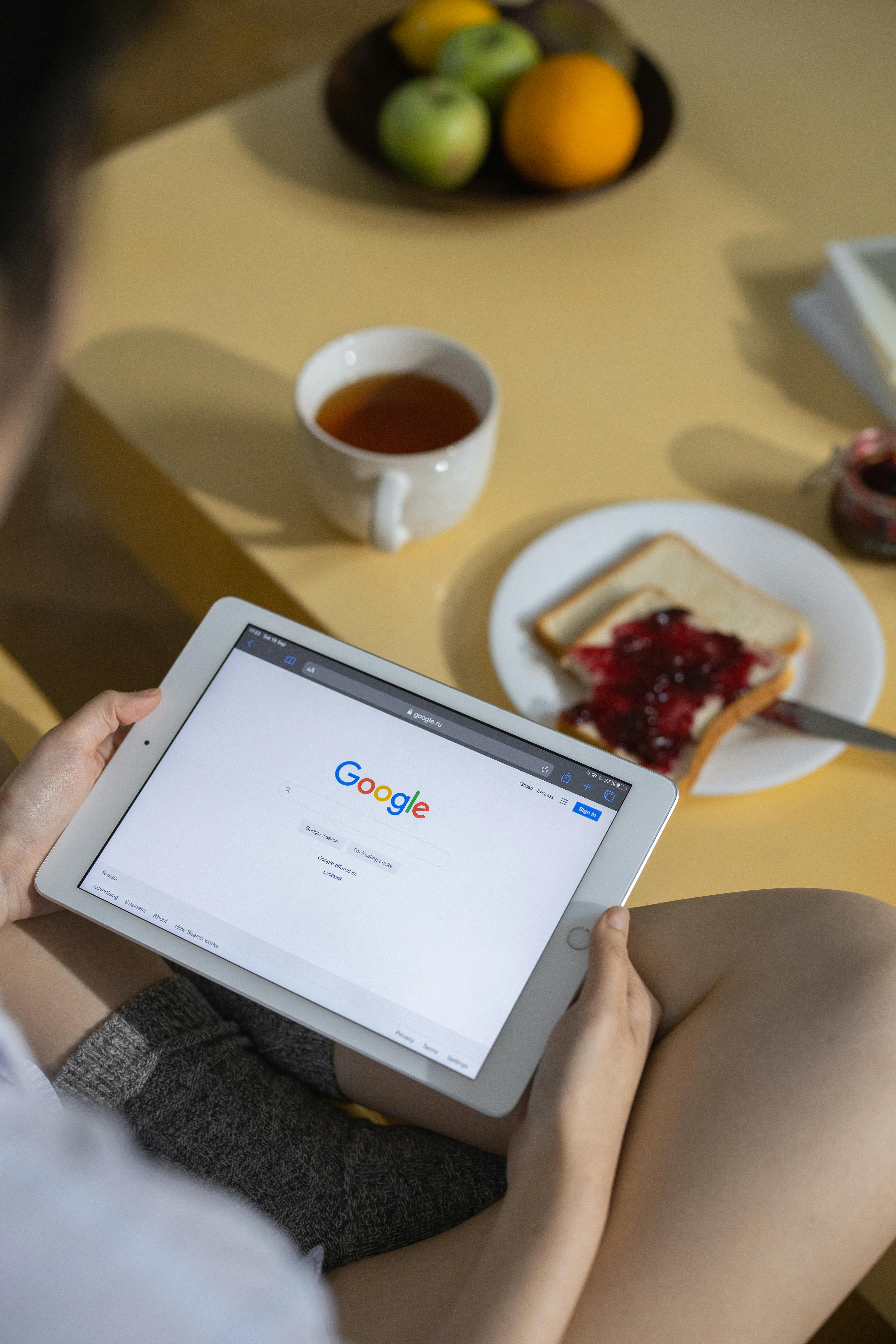 a person holding a tablet sitting