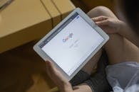 A Person Holding White Ipad Mini