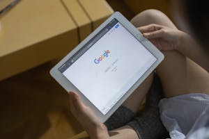 A Person Holding White Ipad Mini