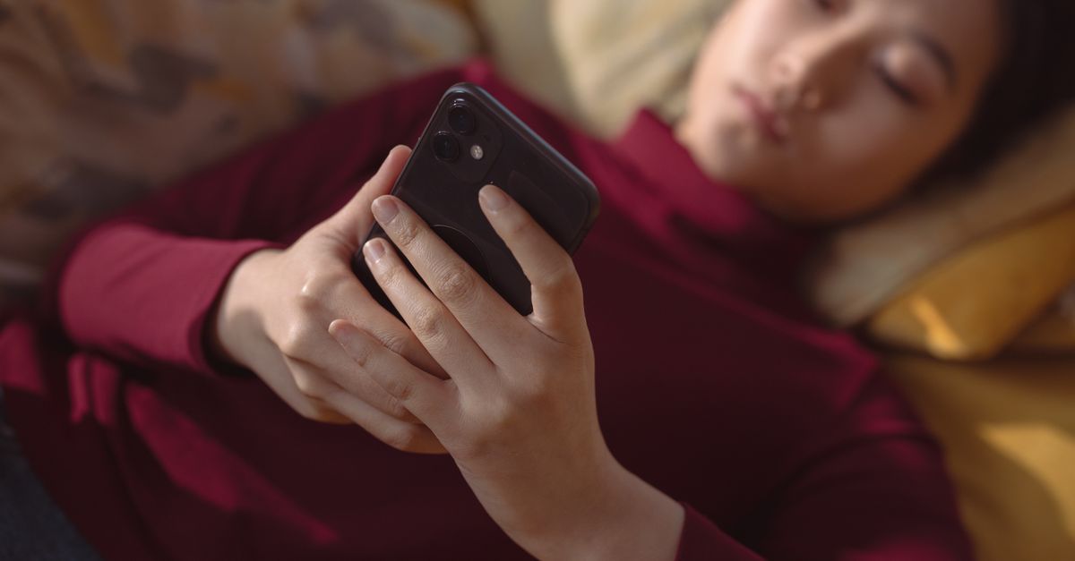 person overwhelmed by smartphone notifications at home