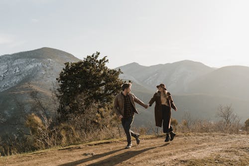 A Couple Running in Mountains