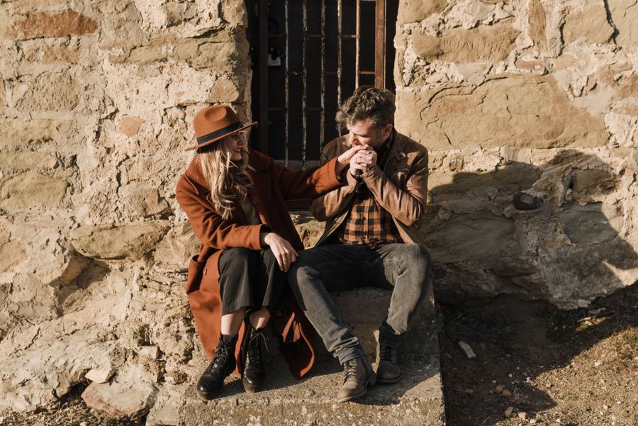 Couple sitting together on a bench near a canal, enjoying a quiet conversation