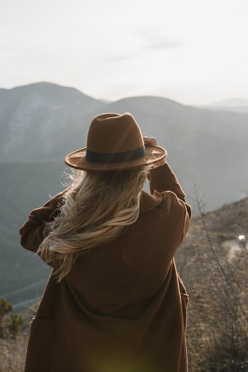 A Woman in Brown Hat and Brown Coat