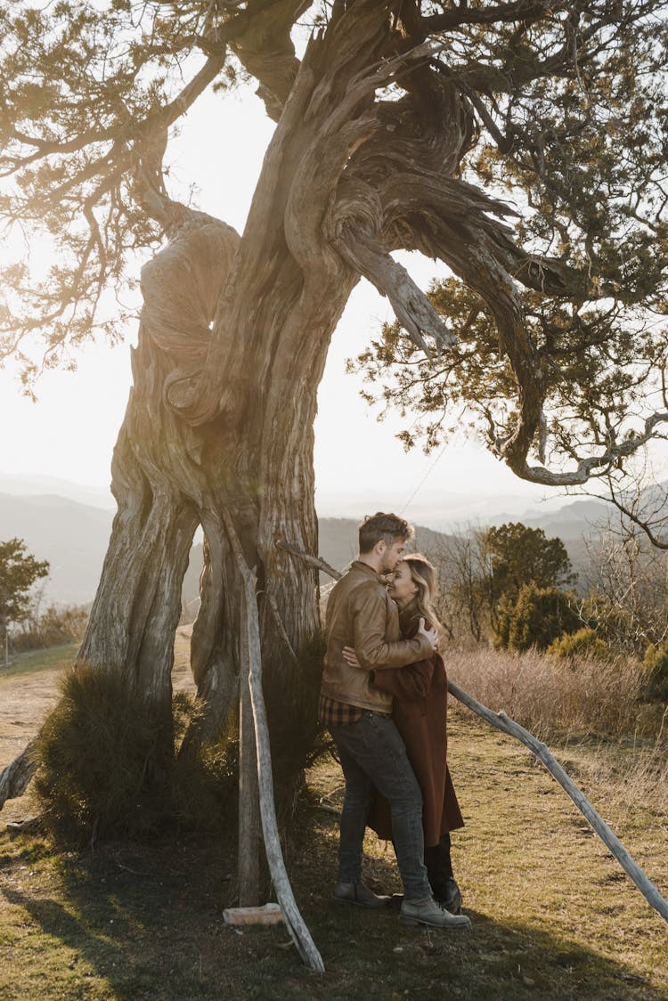 Couple Standing Near A Tree