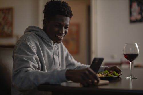 Man on his Phone While Eating
