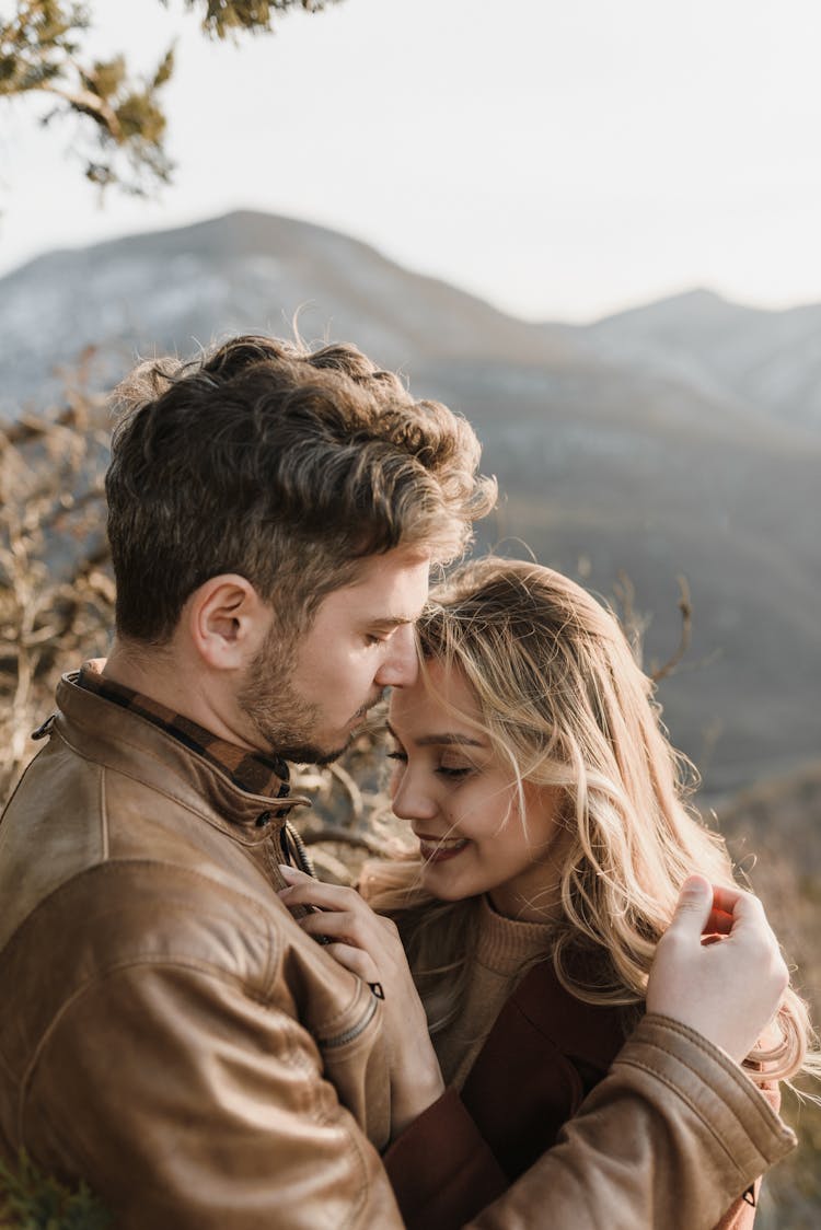 Man In Brown Jacket Looking At Woman