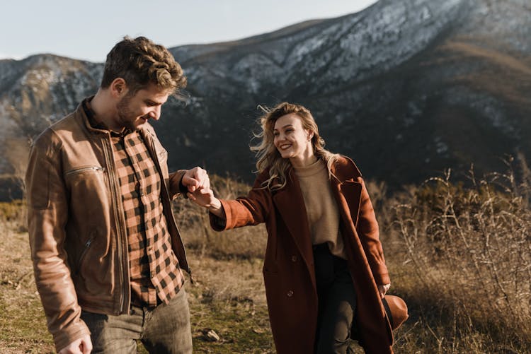 Man Holding Woman's Hand