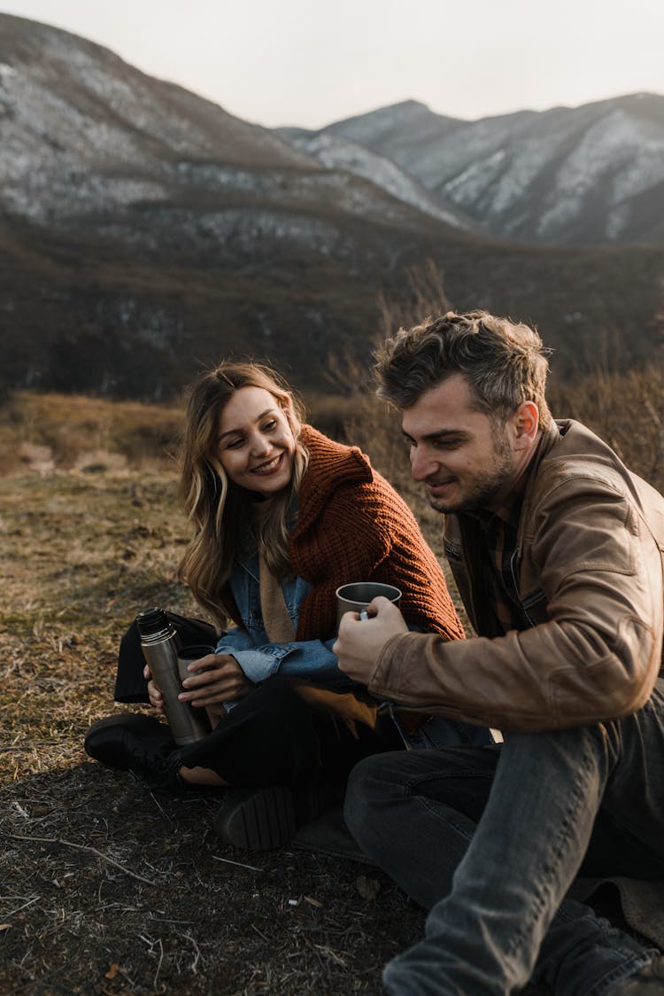 Man And Woman Drinking Hot Drinks