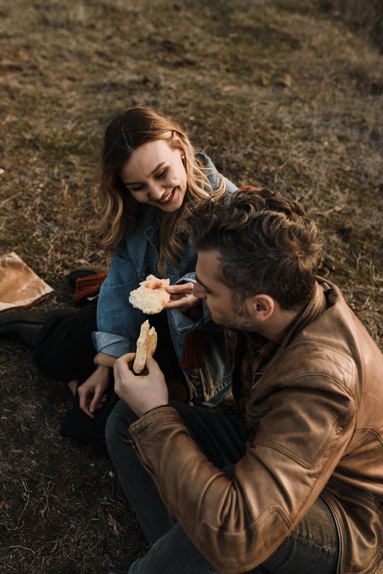 Man And Woman Eating Bread