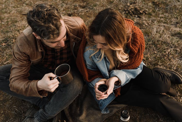 Man And Woman Holding Their Drinks