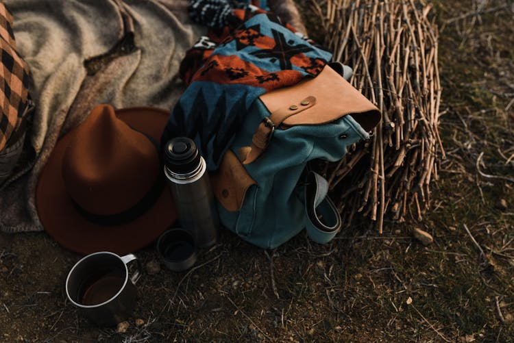 A Close-Up Shot Of A Vacuum Flask Beside A Bag