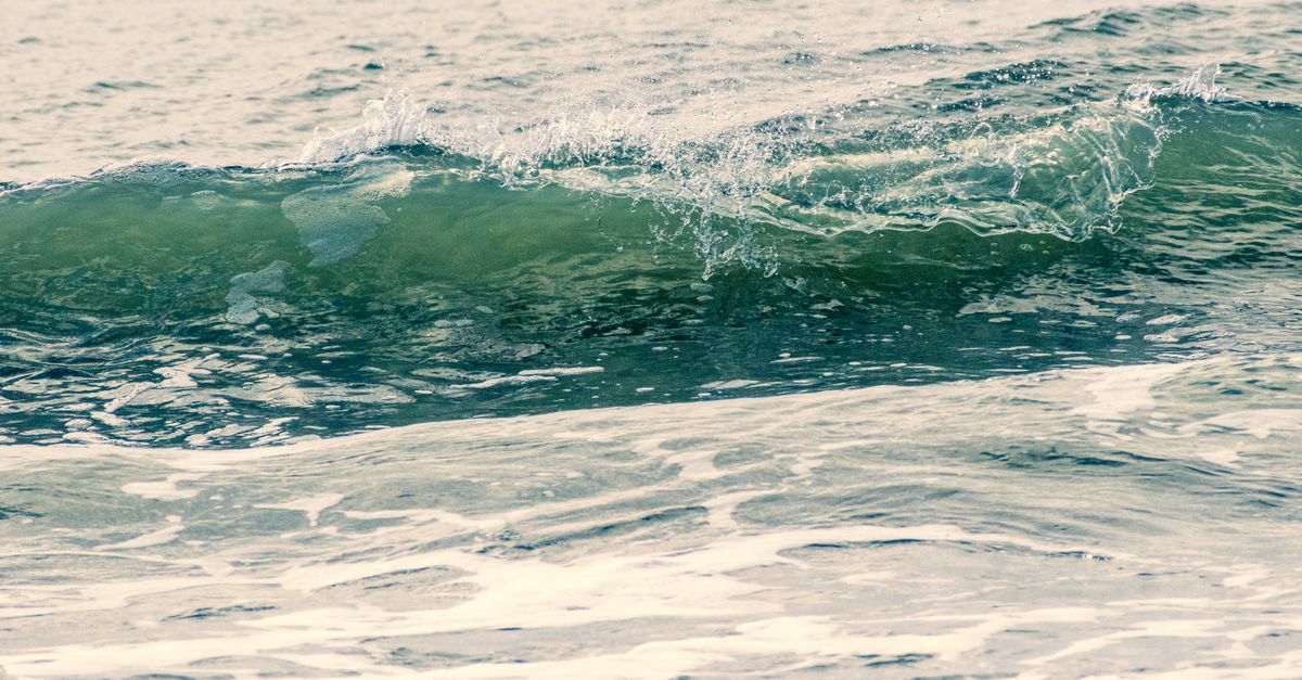 Close-up of ocean waves crashing on Sunset Beach, NC capturing dynamic water motion.