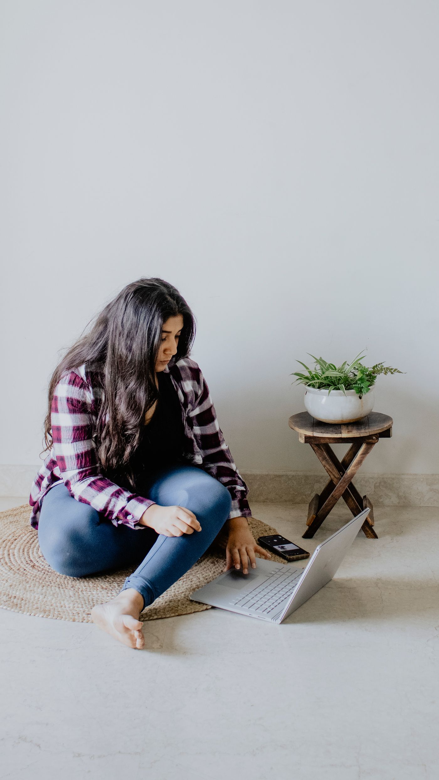 A young Indian woman learning with a laptop, representing practical digital literacy and access.